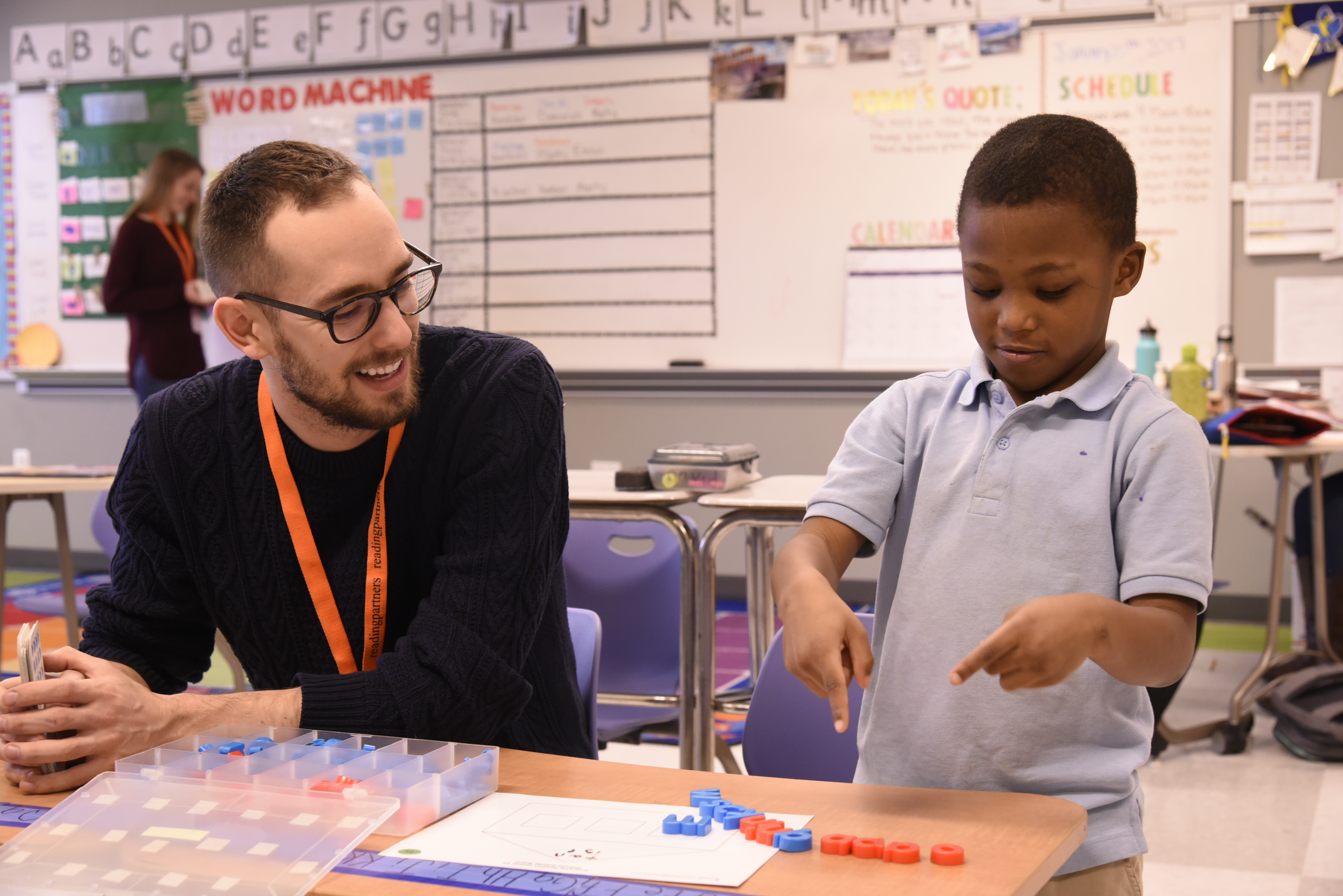 A volunteer with a student