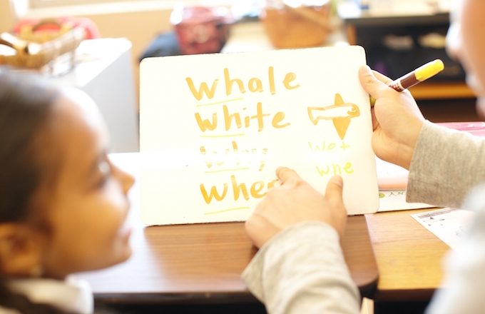 child practicing vocabulary with teacher