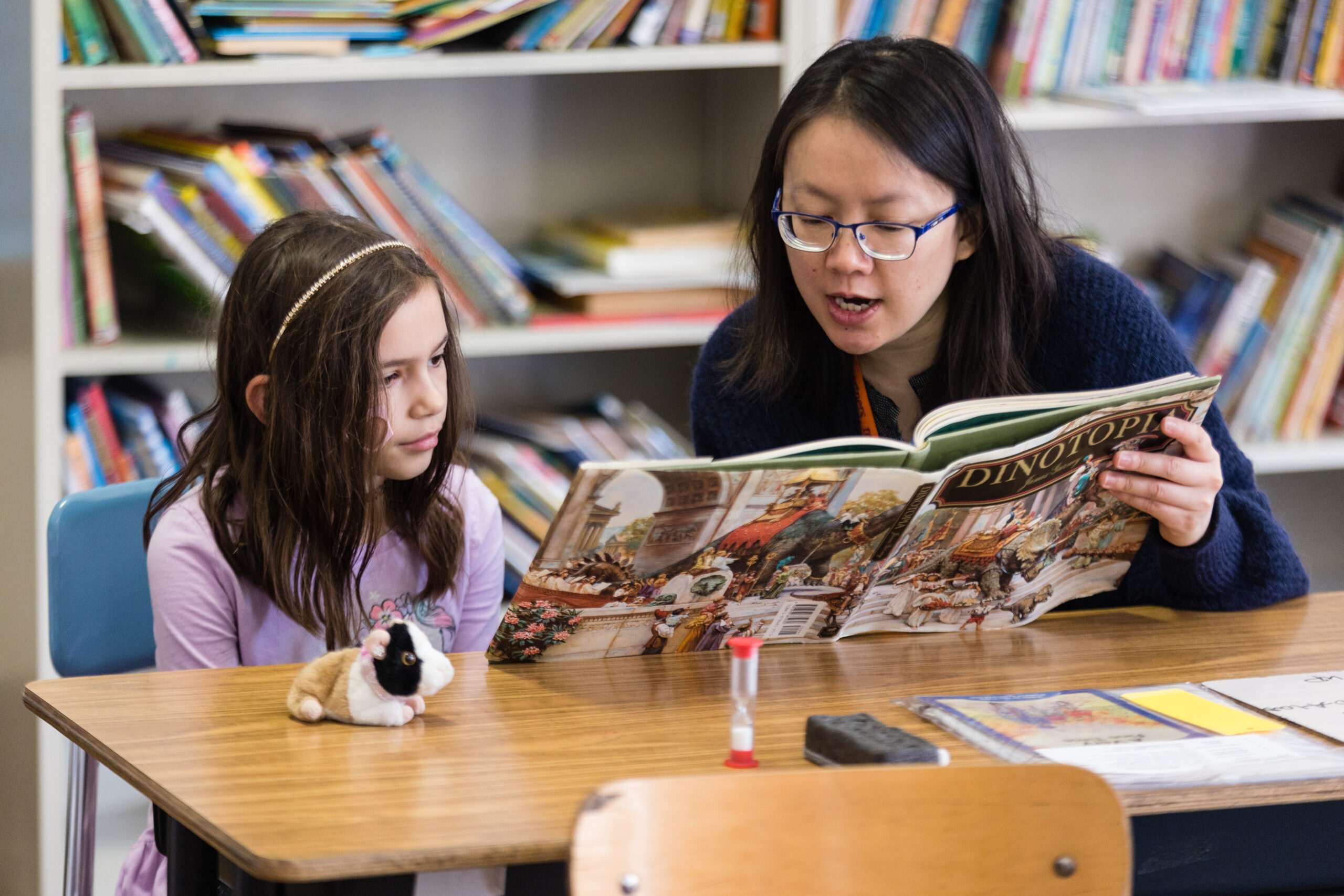 female tutor reading to female student