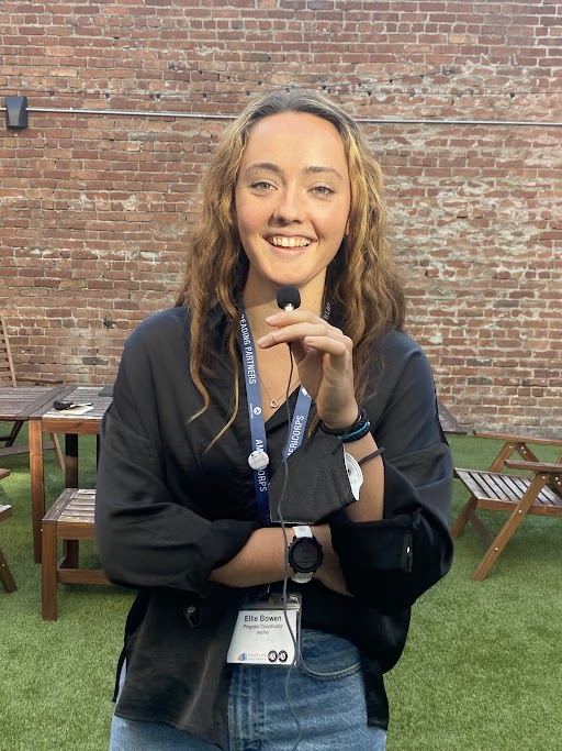 ellie bowen, holding a mini mic and smiling at the camera, americorps service term