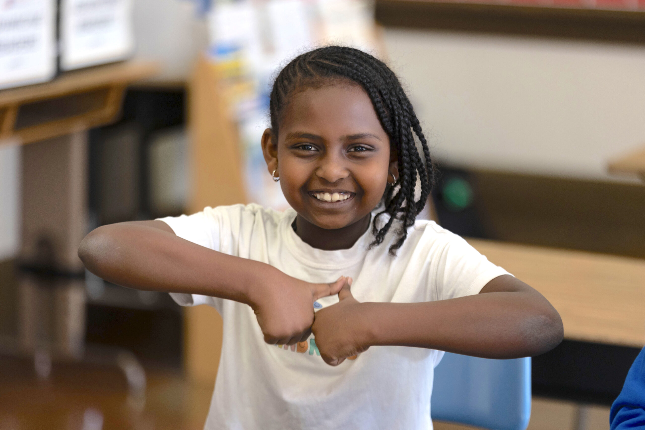 student holding up two thumbs up