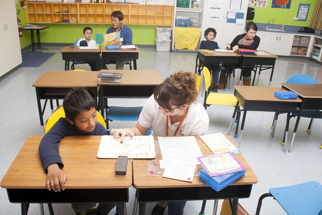 a classroom of student-tutor pairs working through literacy lessons, high-quality pre-k