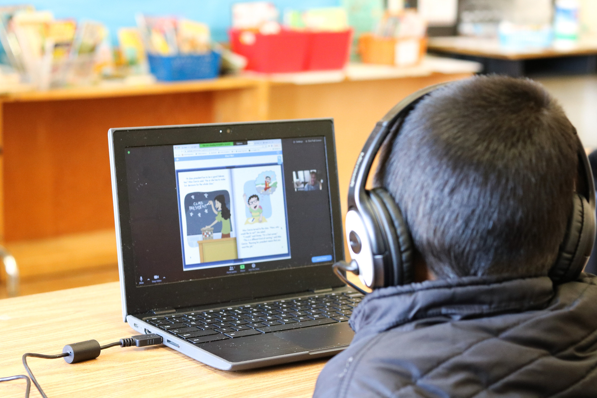 a student stares at a screen where a tutor is delivering systematic phonics instruction