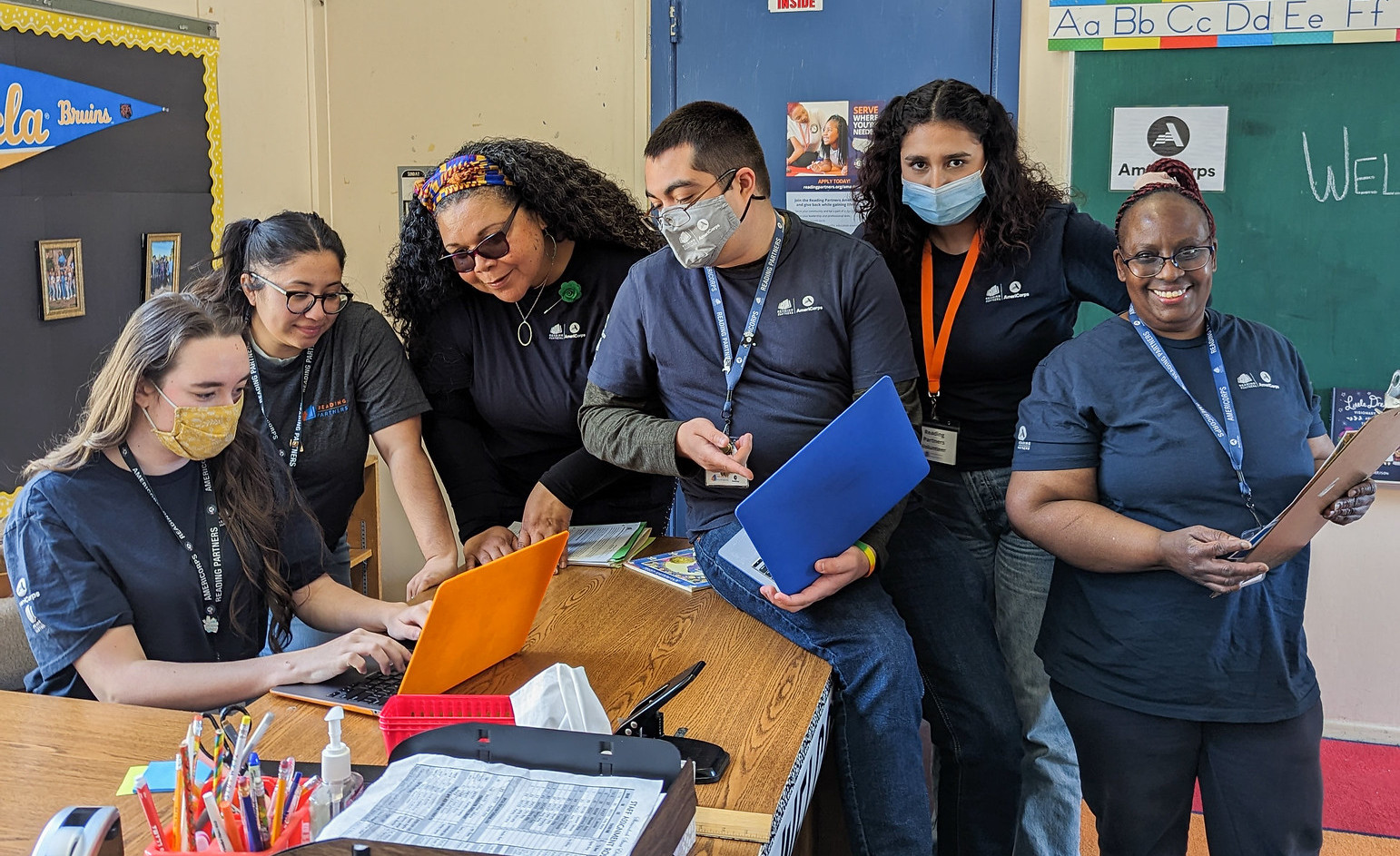 americorps members gathered around a desk