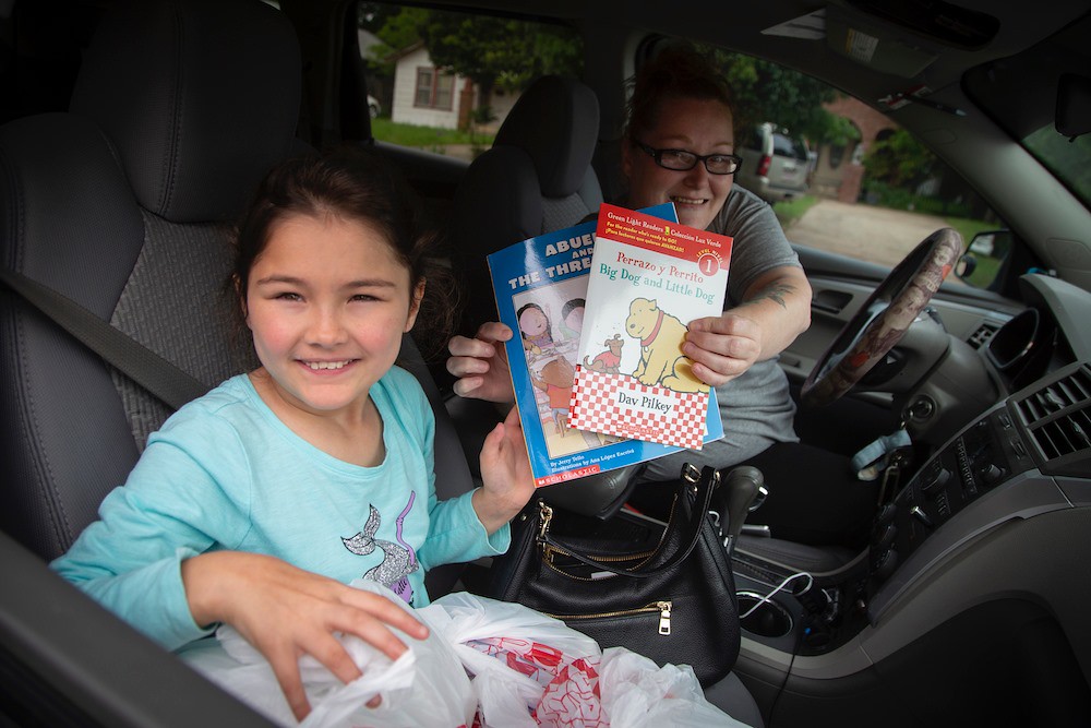 a student receives books from a book drive; meaningful types of giving