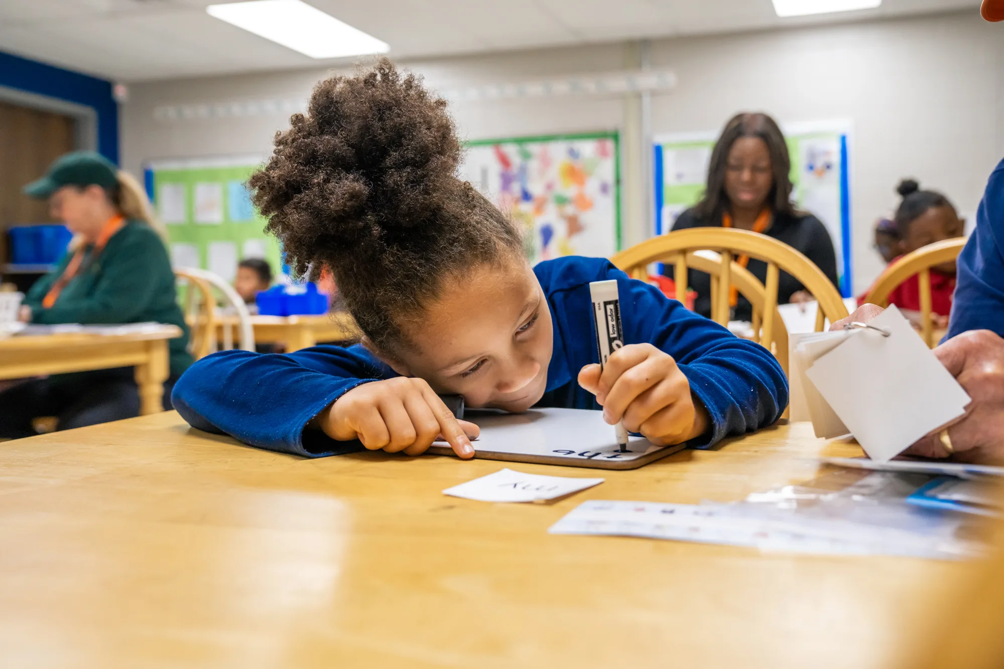 student writing on a white board