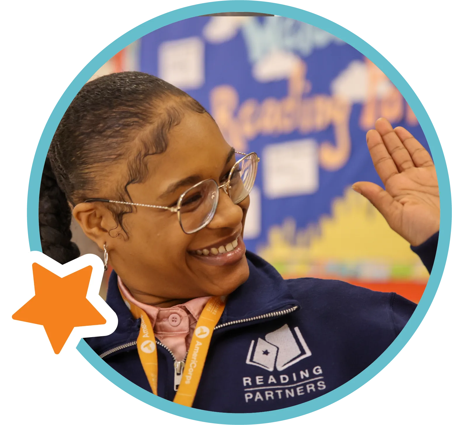americorps member smiling and high-fiving an unseen second person