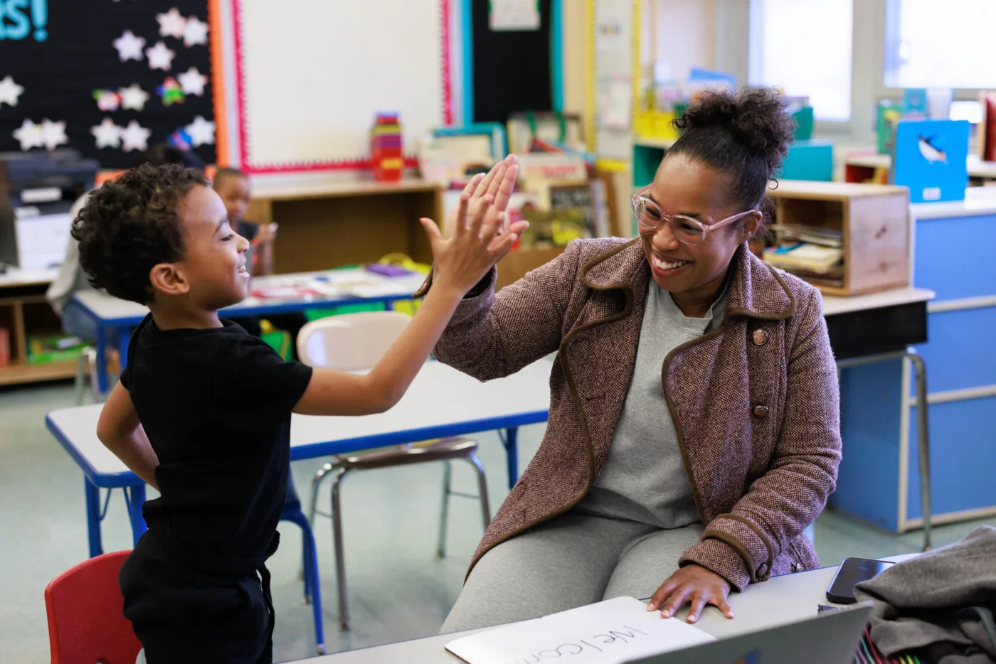 a student and tutor high-fiving