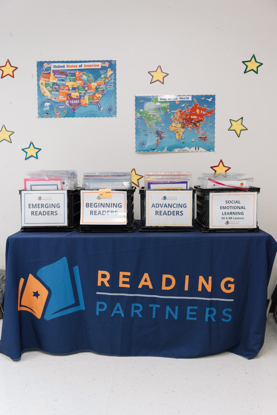 the reading partners curriculum in boxes on a table