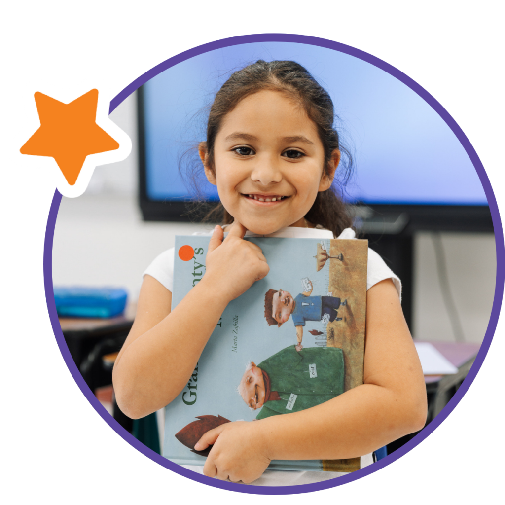 student smiling with book